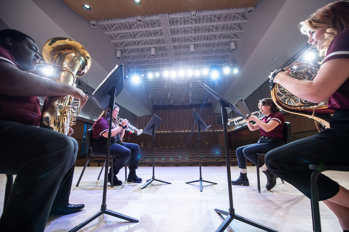 Student musicians play instruments in Music Building