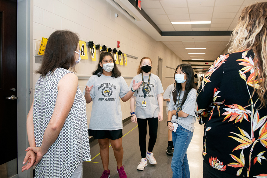 Partnership Middle School seventh graders, from left, Anya Rai, Zayley Plair and Katie Chung provide a tour.