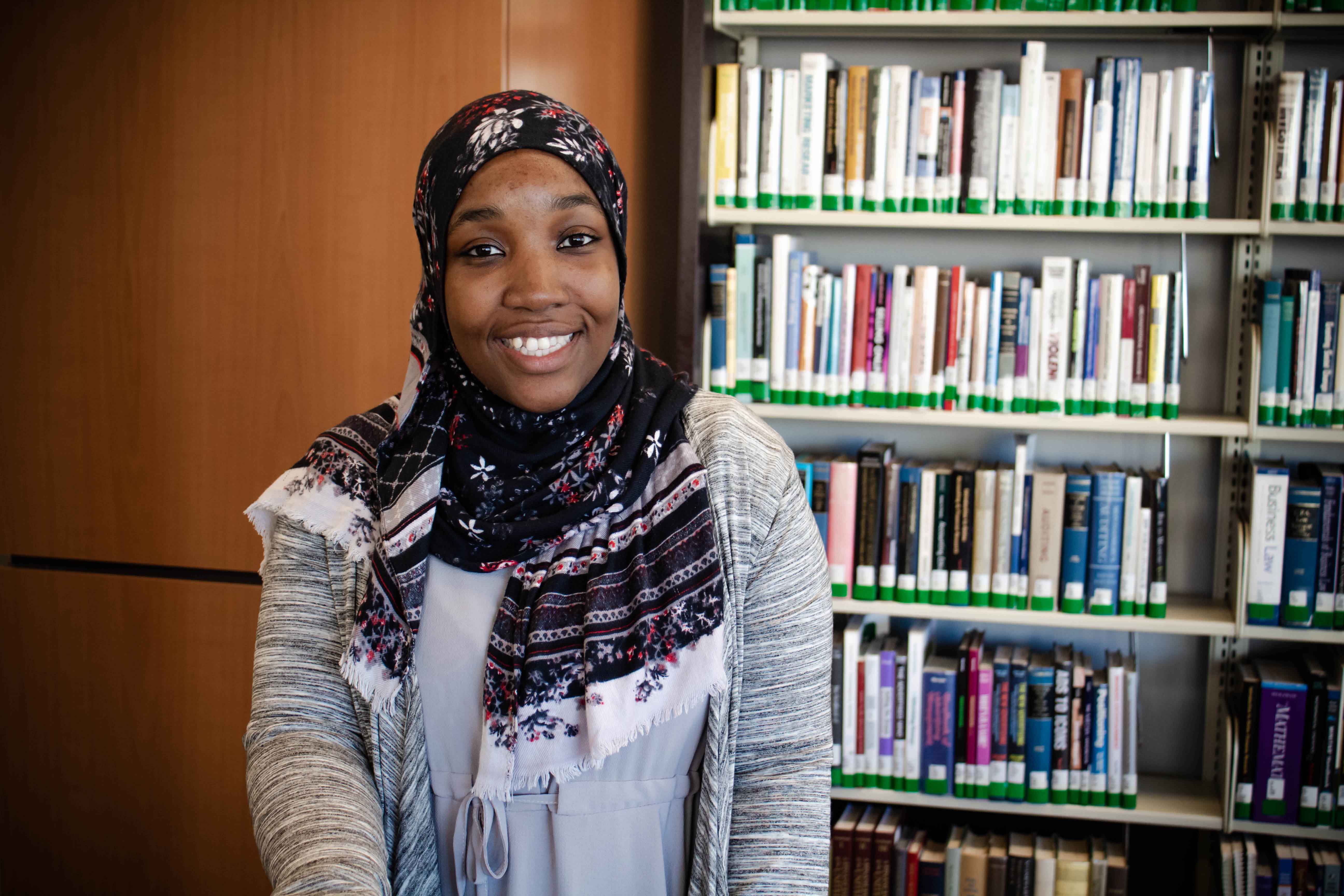 Photo of Jinna Alston in a library