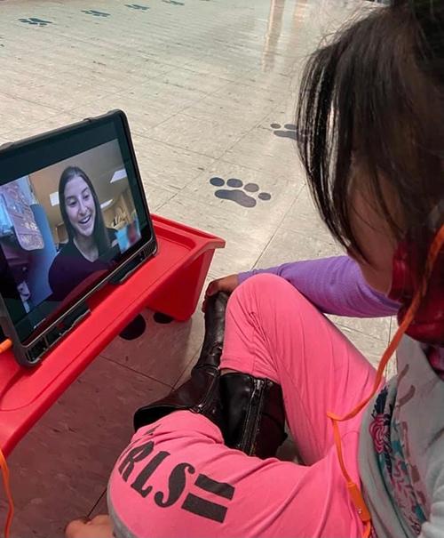 An English Learner student in Scott County interacts with Lauren James, a junior MSU elementary education major from Madison.