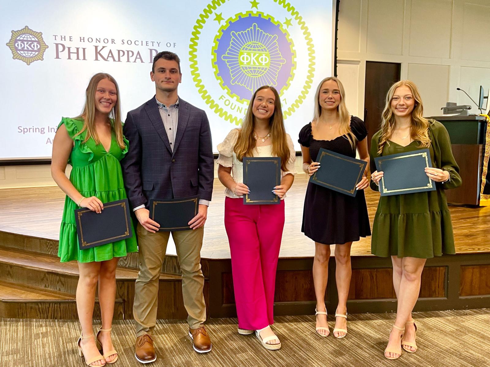 Students hold certificates
