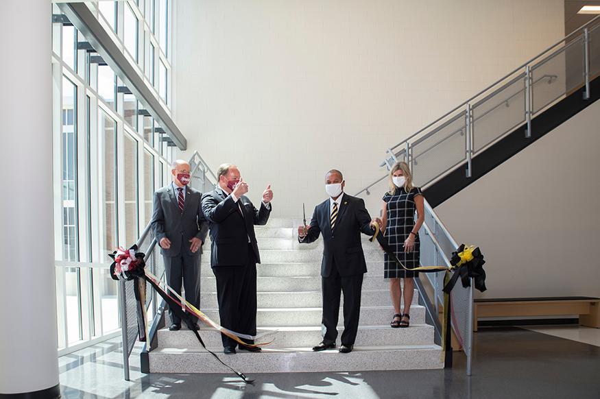MSU President Mark E. Keenum gives a thumbs up after SOSD Superintendent Eddie Peasant cuts a ribbon to mark the opening.