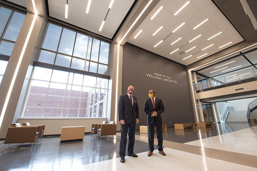 MSU President Mark E. Keenum, left, and SOSD Superintendent Eddie Peasant speak in the atrium of the new Partnership School.