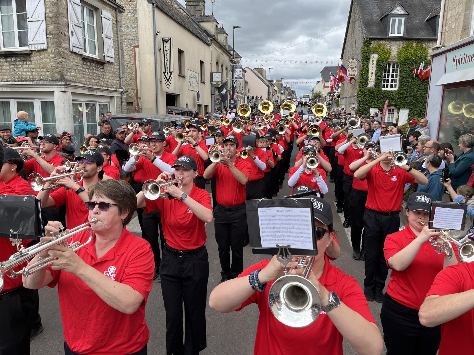 Band members perform in a parade in the streets of France