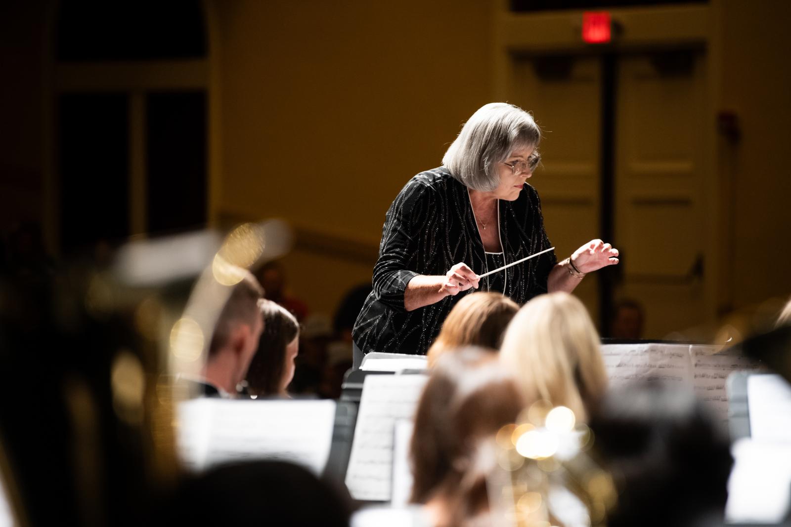 Elva Kaye Lance directs wind ensemble during performance