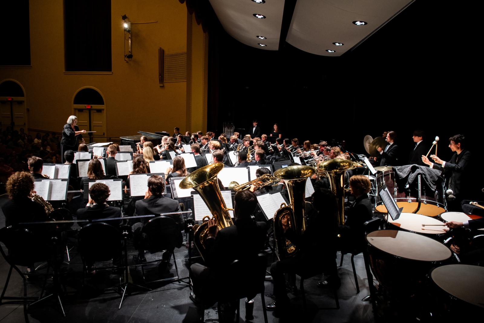 Students perform with instruments onstage at Lee Hall auditorium