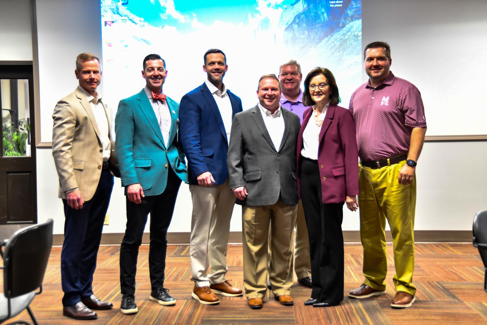 School leaders pose for a photo with Dr. Jayroe and Dr. Morgigno.