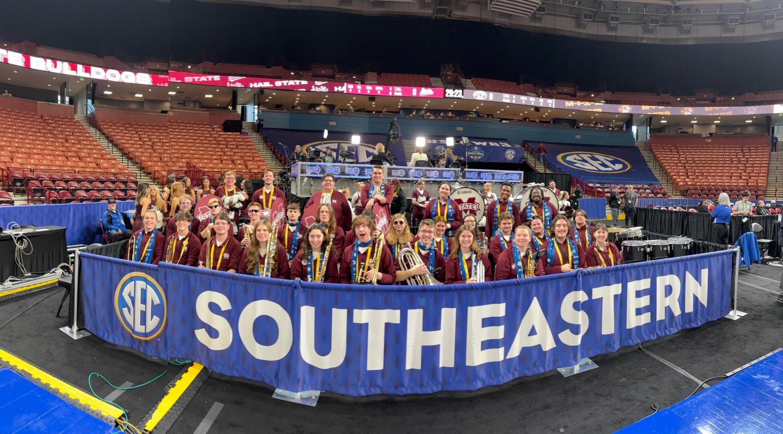Band students posed for a photo inside a basketball arena