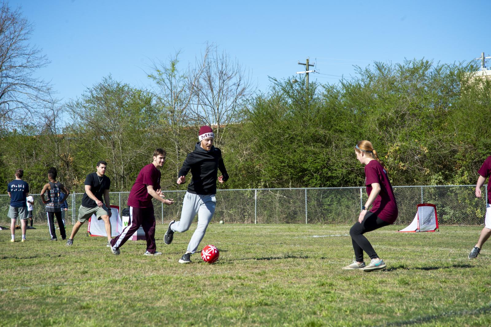 Jamboree participants playing soccer on a field