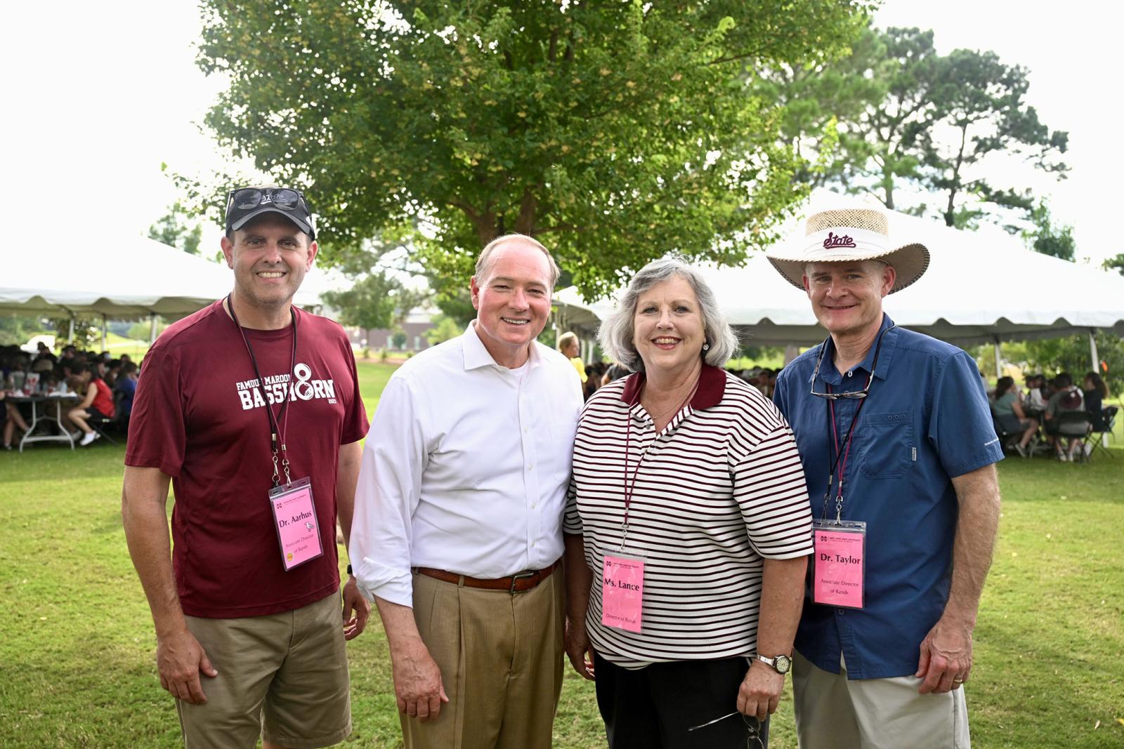 The directors of the band pose for a photo with Dr. Keenum