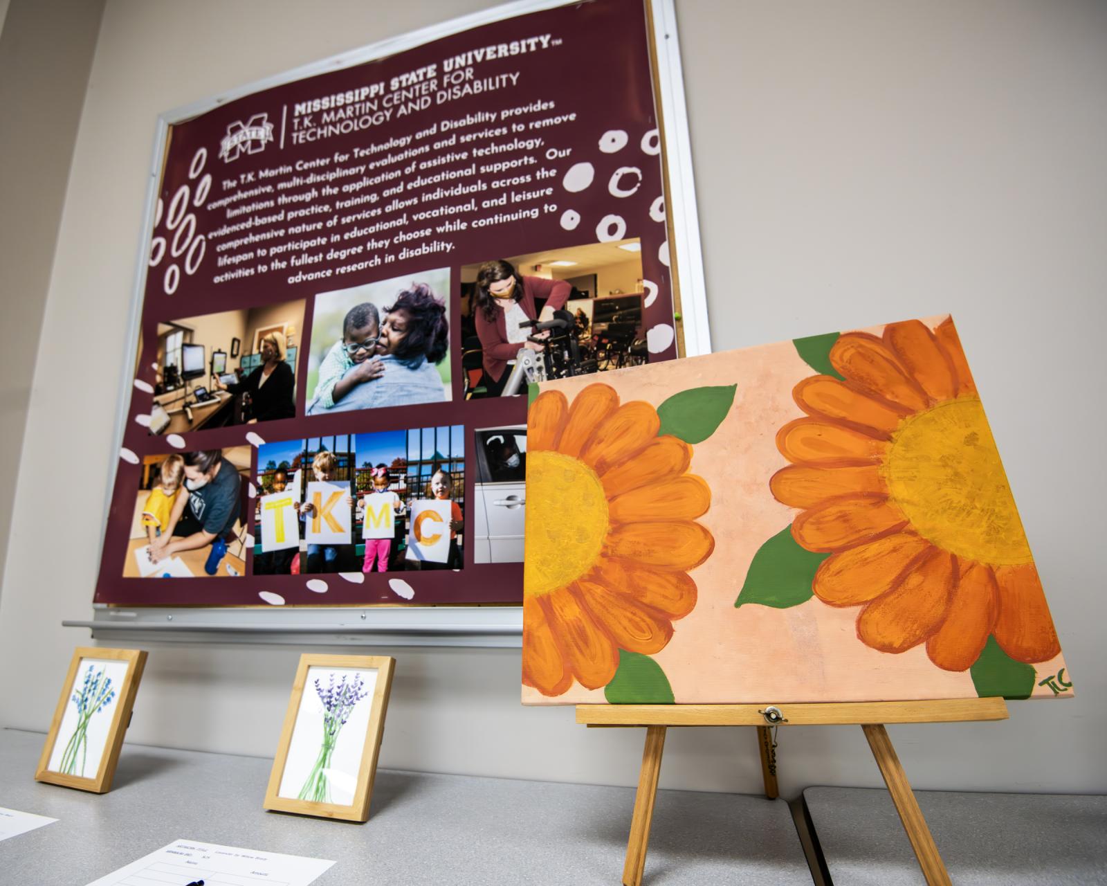 Three pieces of floral artwork on display