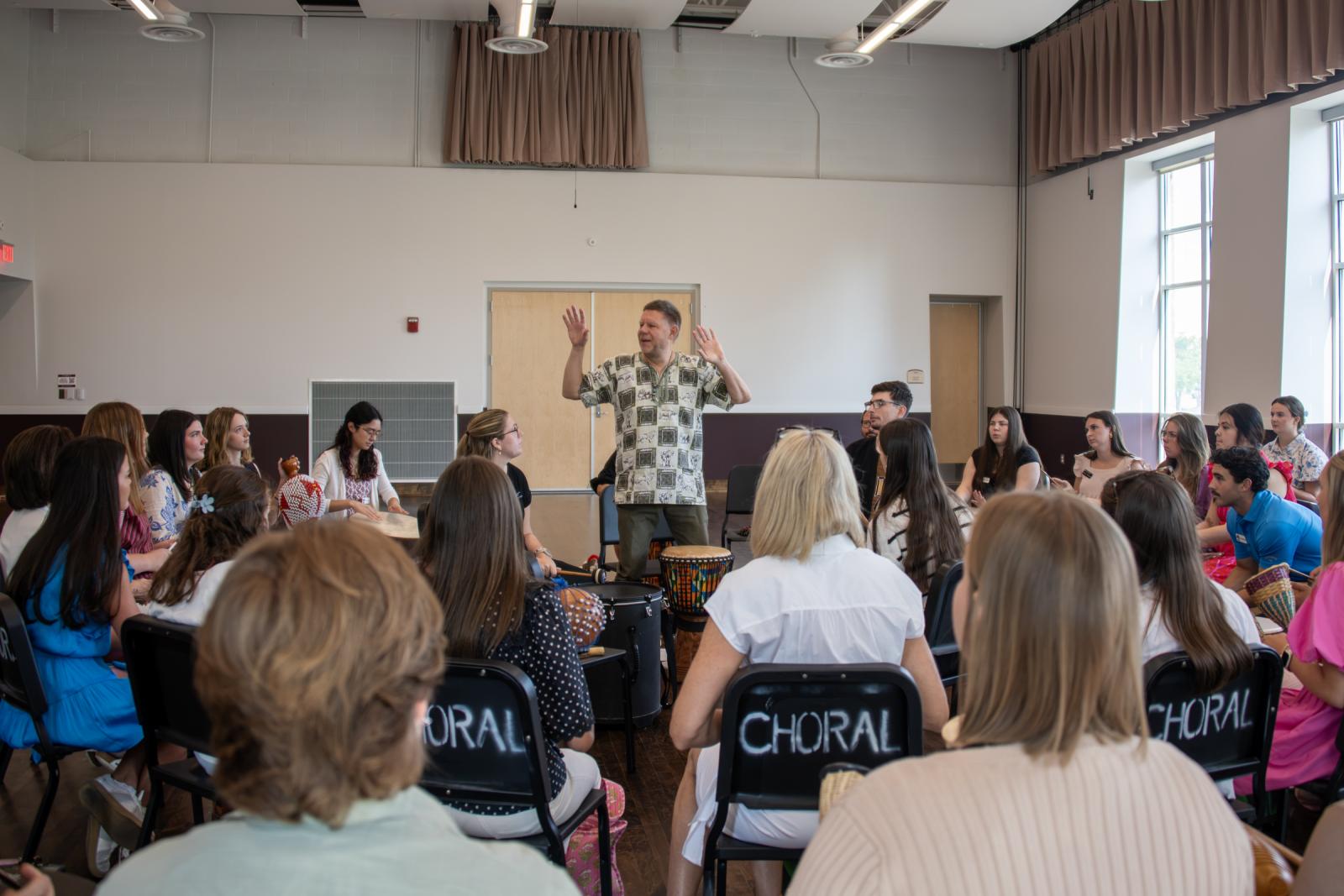 Dr. Damm leads the METP students in a drum circle
