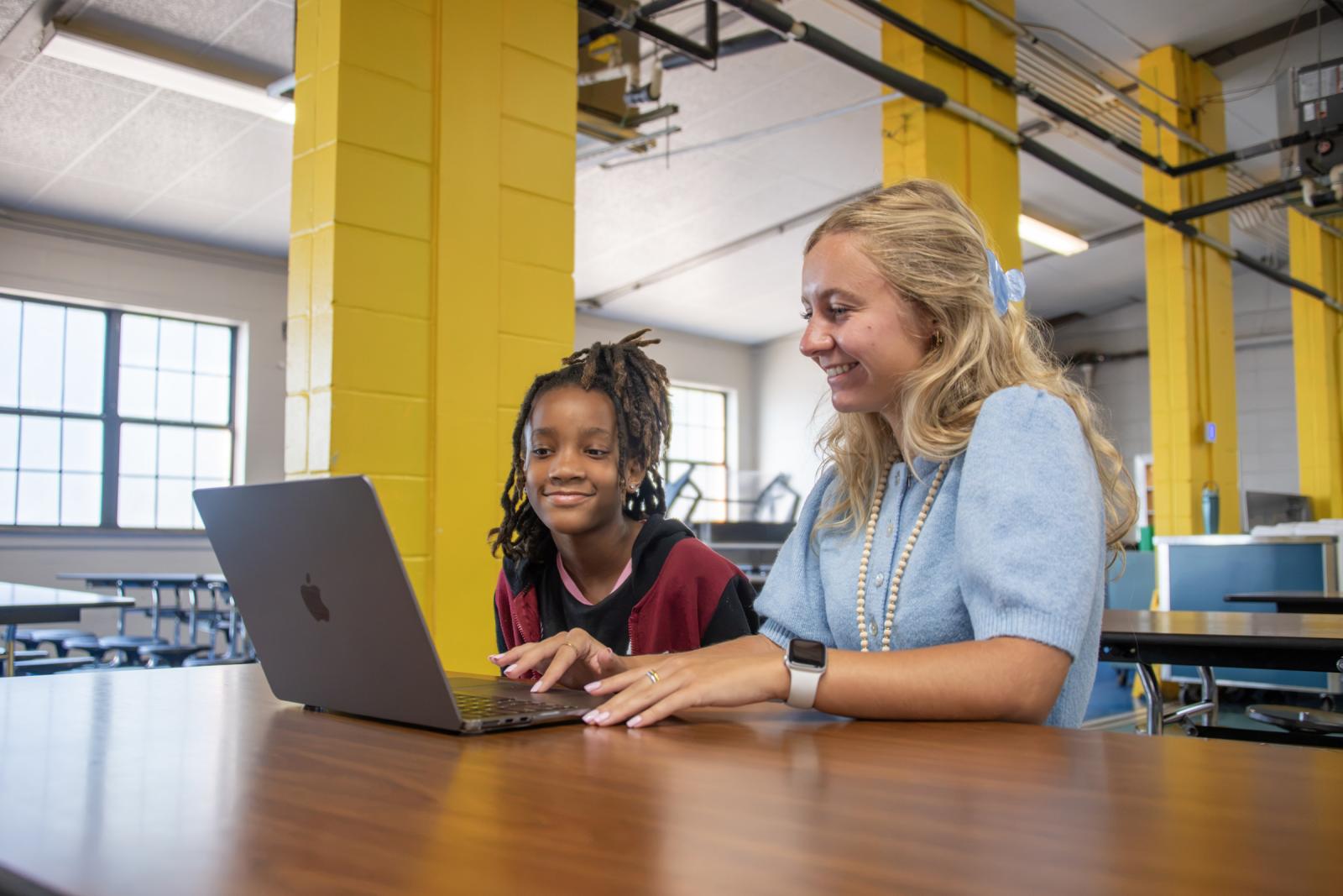 MSU student works with a child at a school