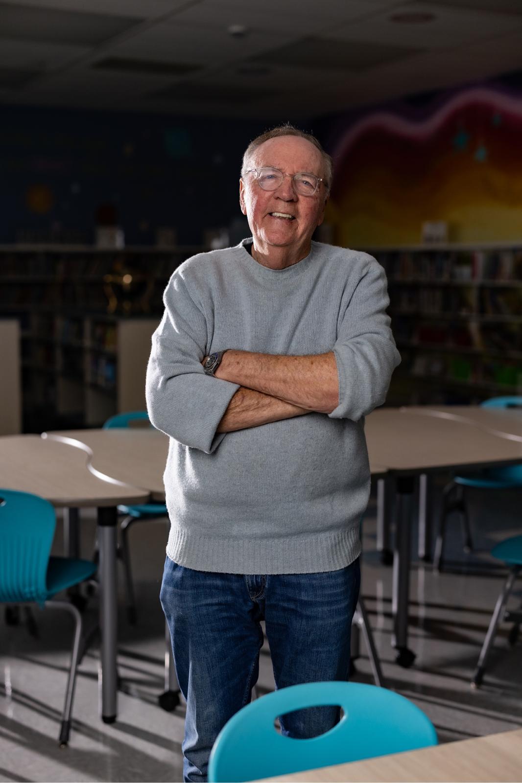 James Patterson standing in a classroom
