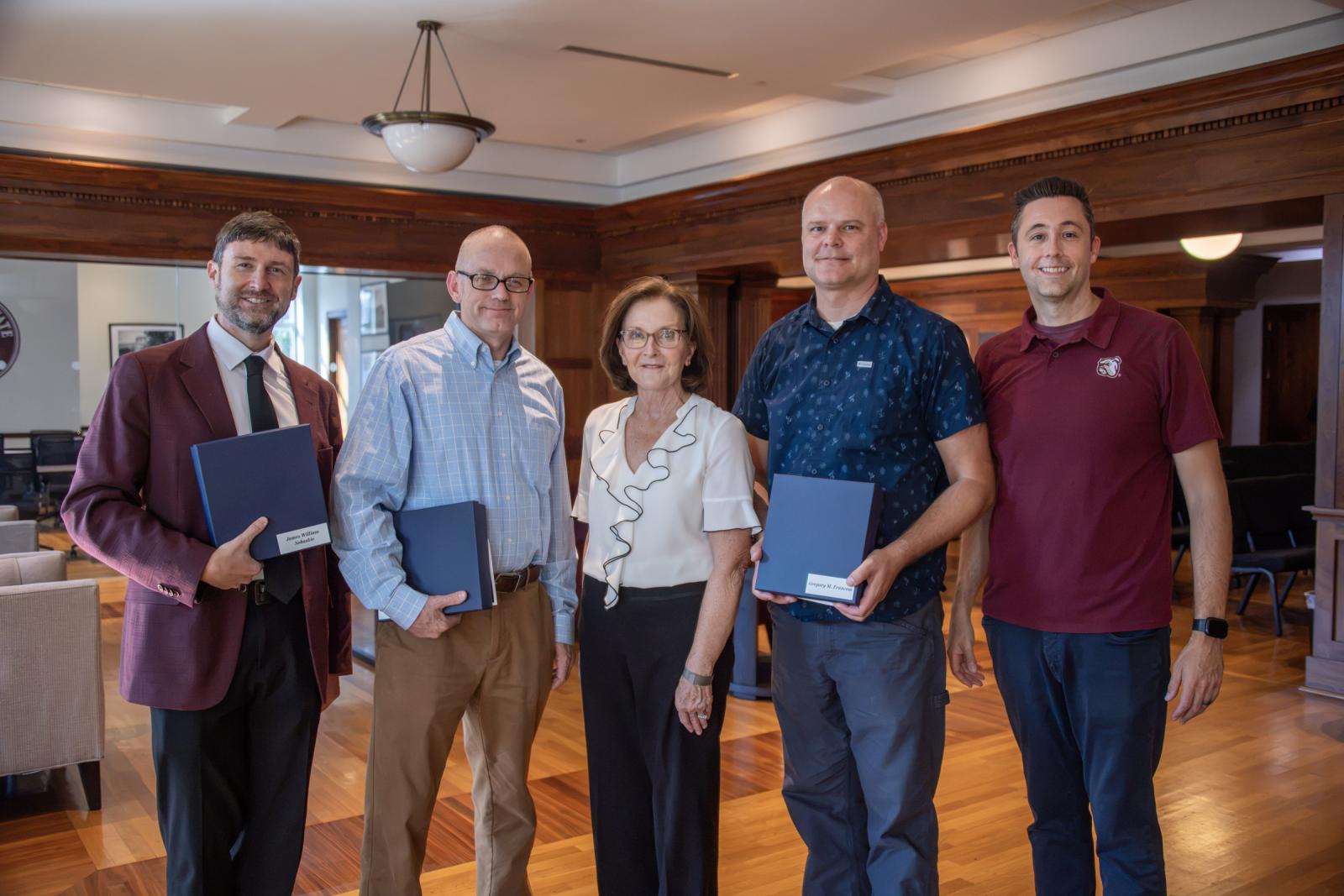 Five faculty and COE leaders standing in the Grisham Room