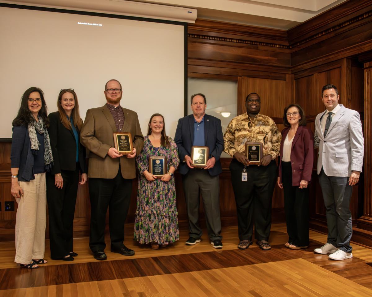 Faculty and staff award recipients pose for a photo with administration