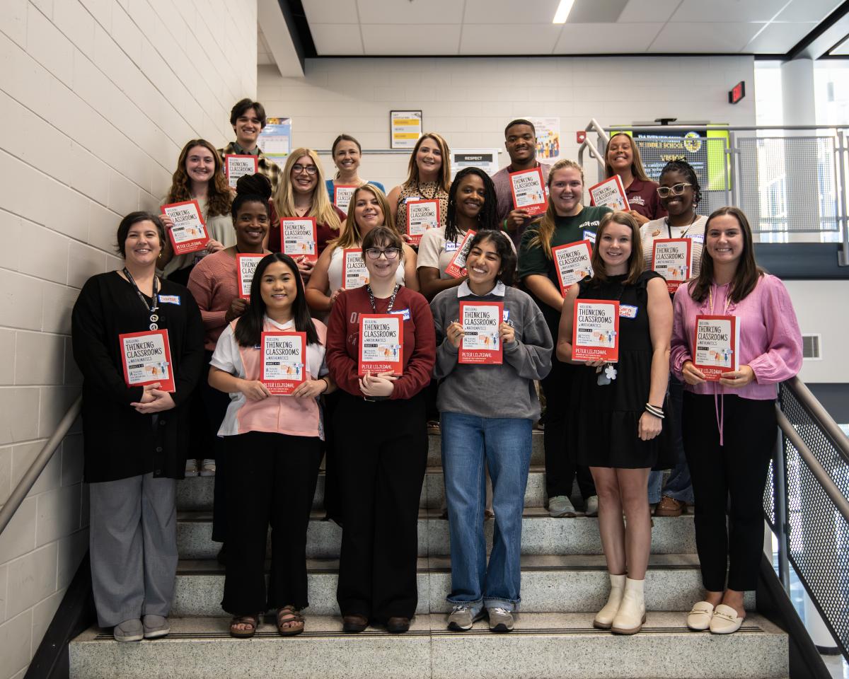 MSU students and Partnership School teachers pose on the stairs