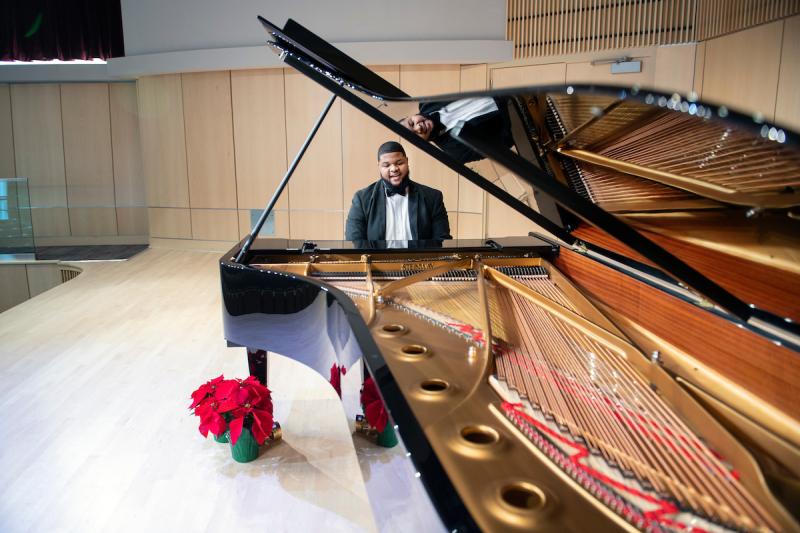Music students plays the piano while singing